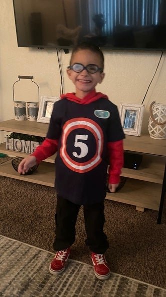 dominic smiling in his living room 