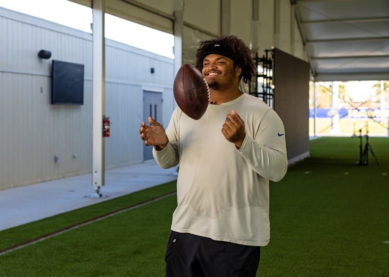 Steve Avila tossing a football midair.