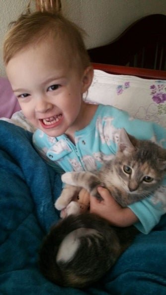 summer as a baby holding a cat