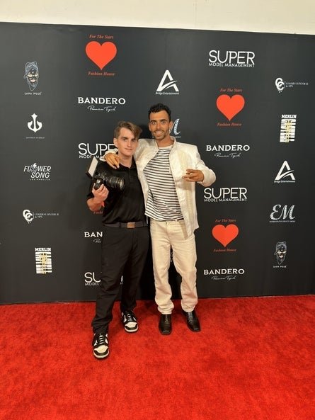 connor standing with his colleague holding a camera