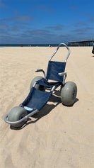 A blue beach wheelchair on the sand at Hermosa Beach 
