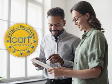 woman and man looking at clipboard