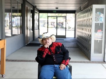 jose sitting down with his hand on his chin wearing a cowboy hat