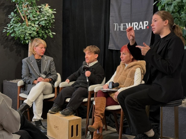 A group of four individuals discussing disability topics on stage for The Wrap.