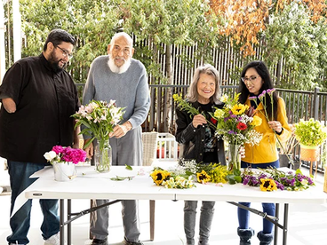 linda and other participants putting flowers in a vase