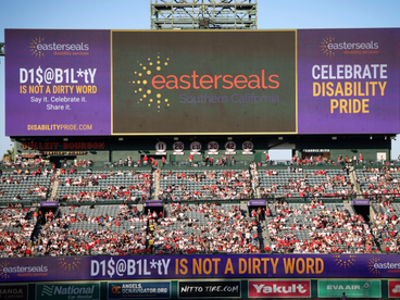 The Angels Baseball score board with the Easterseals logo and on each side graphics for Disability Is Not A Dirty Word campaign. 