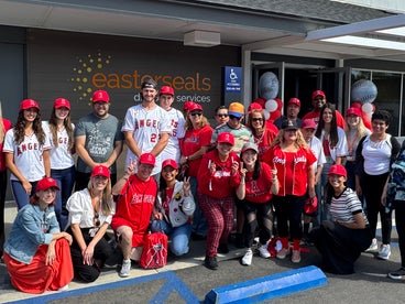 A group of individuals in front of the Easterseals Adult Day Pyott Center. 