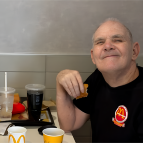 JJ eating a burger at a table