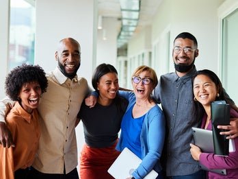 group of people laughing and hugging