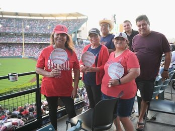 group of adults at a baseball game
