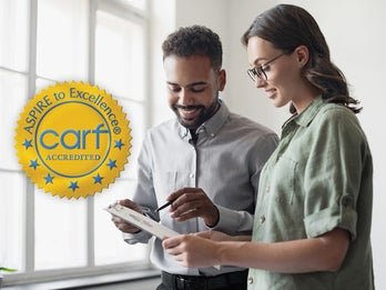 woman and man looking at clipboard