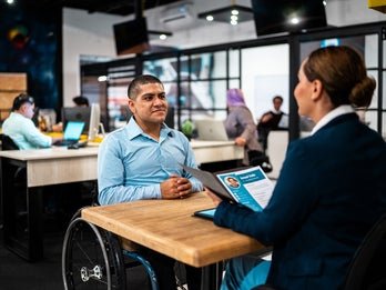 man in wheelchair being interviewed