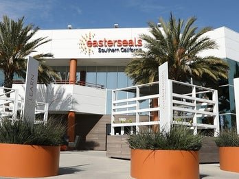 Front view of the Easterseals Southern California building, featuring a modern design with large potted plants at the entrance.