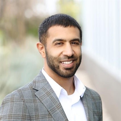 A professional headshot of Dr. Shaji Haq.