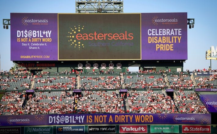 Easterseal's Disabiltiy is Not a Dirty Word signage displayed above the crowd on the LED screens