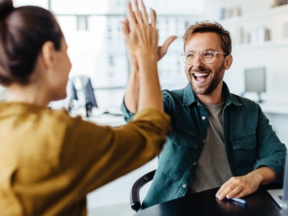 person in chair high fiving