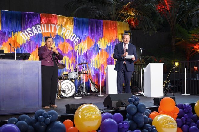Easterseals CEO Mark Whitley on the right giving a speech with an ASL interpreter on the left 