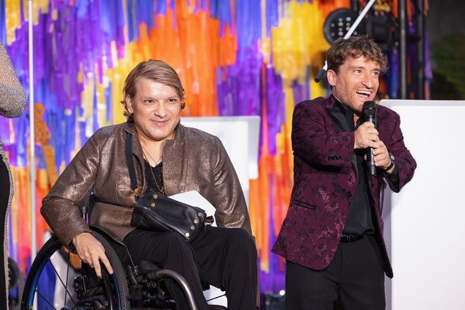 Andy Arias on the left and Nic Novicki on the right on stage at Disability Pride event