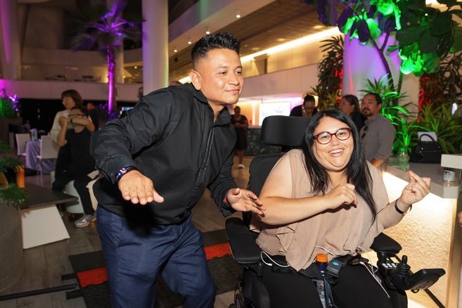 PSA cast member Betty Partida dancing with an ESSC staff member 